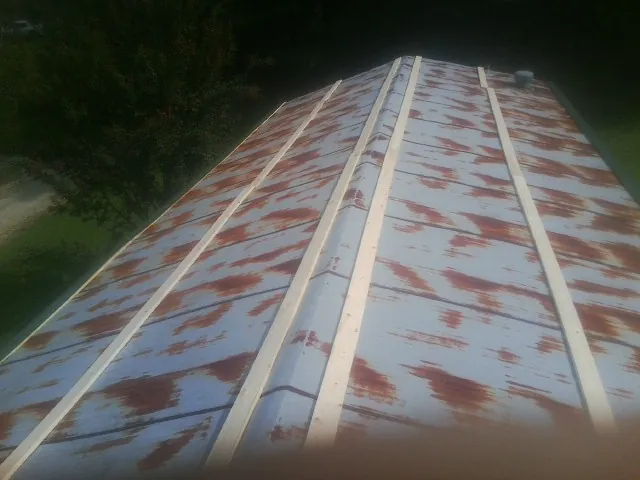 Rusted metal roof panels with new wood purlins before replacement — Storm Damage Roof Repair in Fort Smith by Roofing Brothers